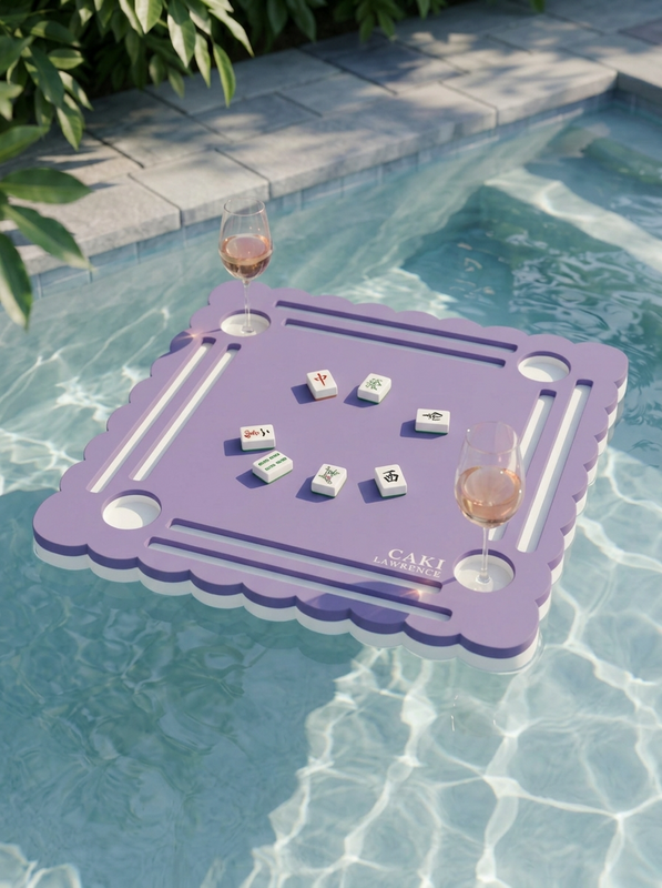 Purple Wisteria mahjong mat floating on a pool with rosé and American mahjong tiles